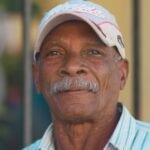 Adulto mayor colombiano beneficiario del programa Colombia Mayor recibiendo apoyo económico y servicios sociales del gobierno